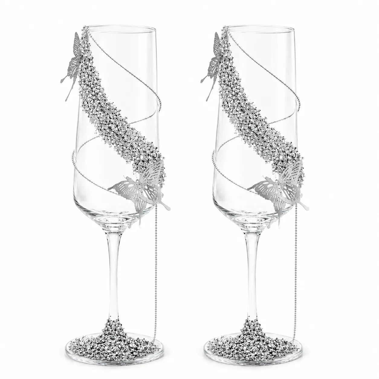Two decorative champagne flutes with silver embellishments on a white background